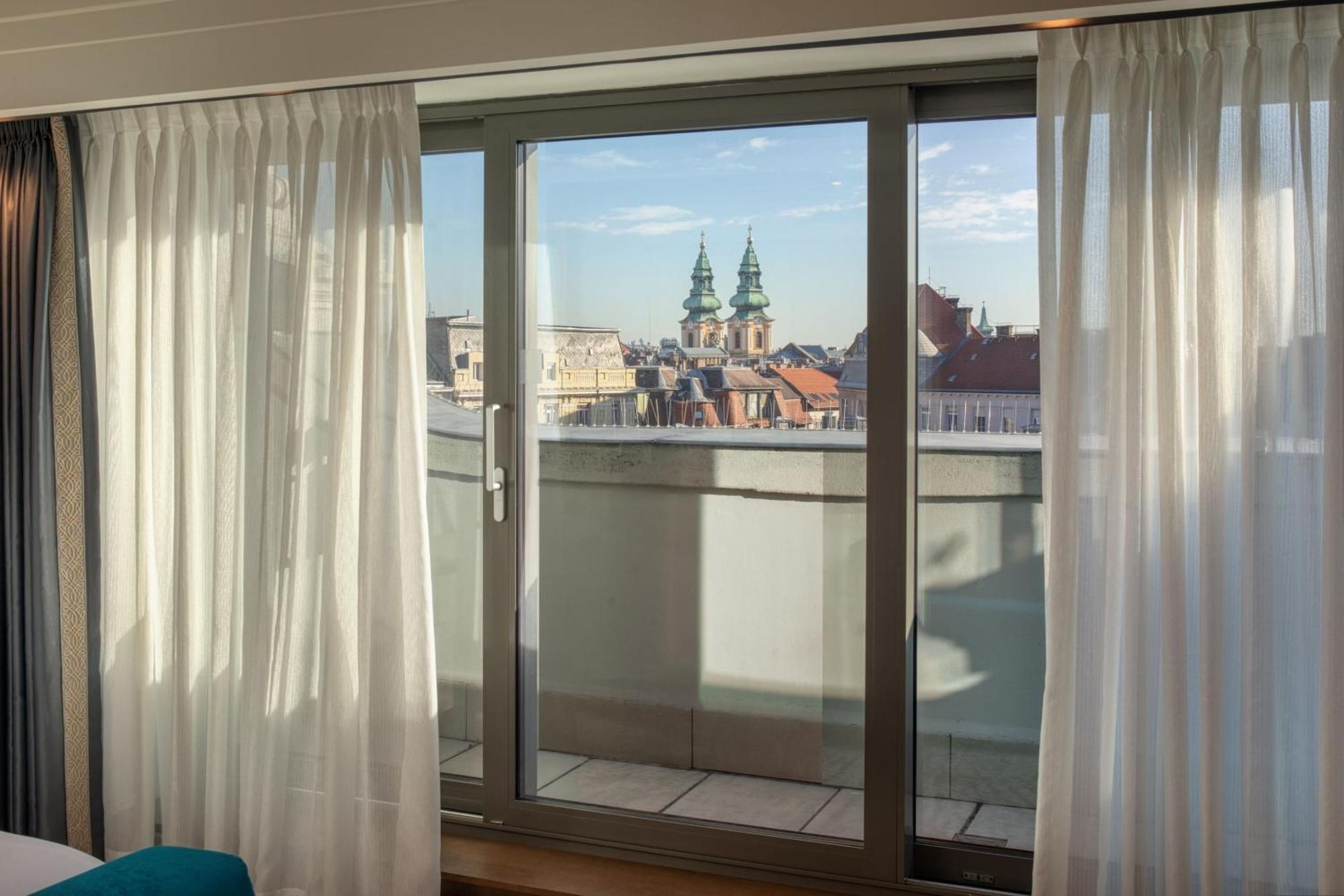 Zimmer mit Kingsize-Bett, Balkon und Stadtblick